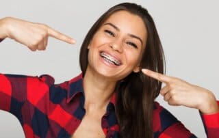Face of a young woman with braces on her teeth